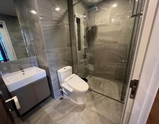 Modern bathroom with glass shower enclosure and sleek fixtures