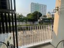 Balcony with view of parking area and city buildings