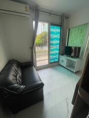 Living room with black leather sofa, air conditioning, and sliding glass doors