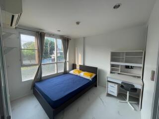 Bright bedroom with a bed and study desk