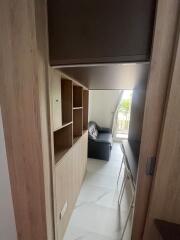 living area with sofa and wooden shelving