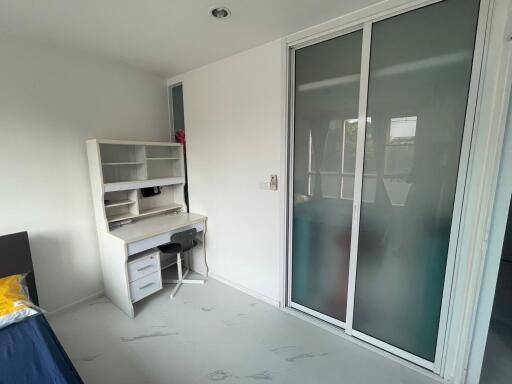 Modern bedroom with study desk and sliding-door closet