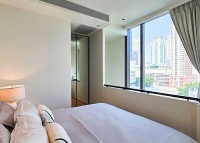 cozy bedroom with large window and city view