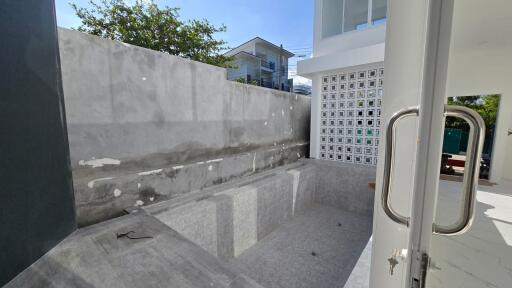 empty outdoor pool area with wall