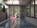 Outdoor swimming pool with a pink flamingo float