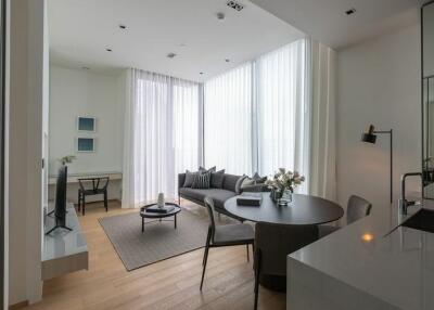 Bright and modern living room with a comfortable seating area and a dining table