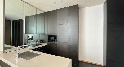 Modern kitchen with dark cabinets and appliances.