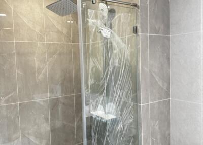 Modern bathroom with tiled walls and a glass-enclosed shower