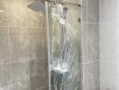 Modern bathroom with tiled walls and a glass-enclosed shower