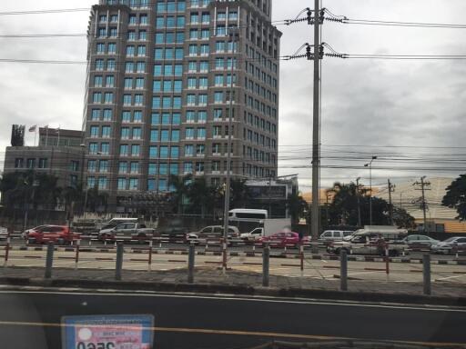 Exterior view of a tall building with street and parked cars