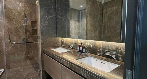 Modern bathroom with dual sinks and a walk-in shower