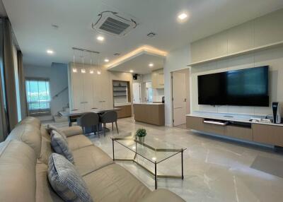 Modern living room with open kitchen and dining area