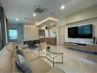 Modern living room with open kitchen and dining area