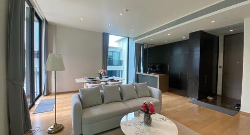 Modern living room with open dining area and balcony view