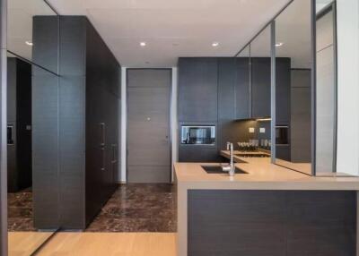 Modern kitchen with dark cabinets and mirrored walls