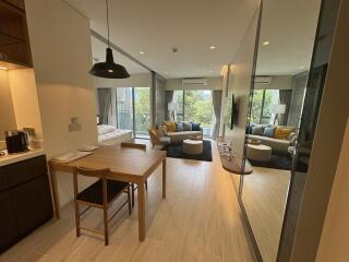 Open-concept dining area leading to living space with natural light