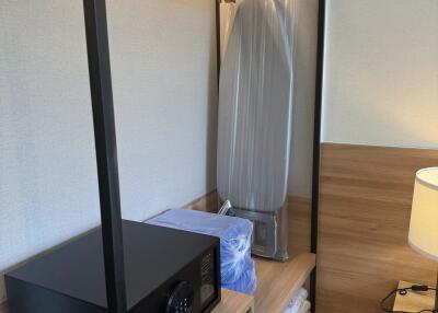 closet with safe and ironing board in bedroom