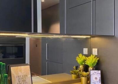 Modern kitchen with dark cabinetry and sleek appliances