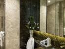 Modern bathroom with beige marble walls, shower area, and a dark marble countertop