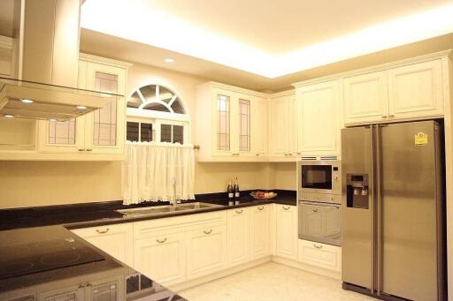 Modern kitchen with white cabinetry and stainless steel appliances