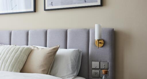 Modern bedroom with upholstered headboard and framed artwork