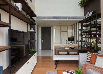 Modern living room with shelving and kitchen view