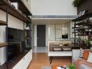 Modern living room with shelving and kitchen view