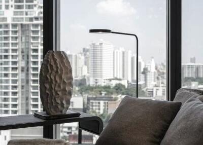 Modern living room with large windows and a view of the city skyline