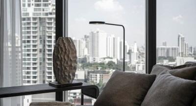 Modern living room with large windows and a view of the city skyline