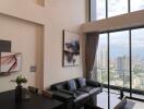 Spacious living room with large windows offering city views