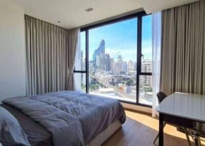 Bedroom with a city view and work desk