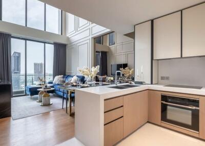 Modern kitchen with open living area featuring large windows