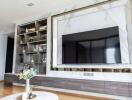 Modern living room with large TV and stylish shelving