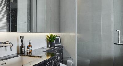 Modern bathroom with marble sink and shower area