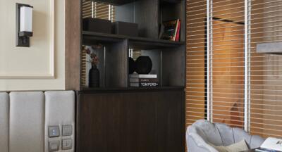 Modern living room with a bookshelf and seating area