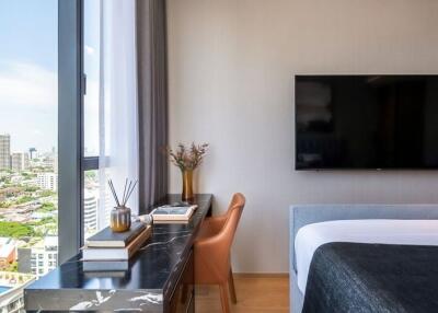 Bedroom with large window and city view