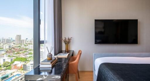 Bedroom with large window and city view