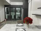 Modern dining area with marble table and vibrant red flowers