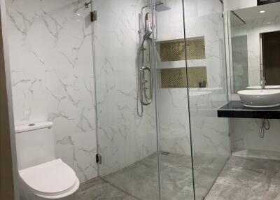 Modern bathroom with glass shower enclosure and rain shower head