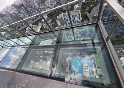 Glass-floored balcony with city view