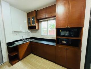 Modern kitchen with wooden cabinets and black countertops