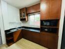 Modern kitchen with wooden cabinets and black countertops