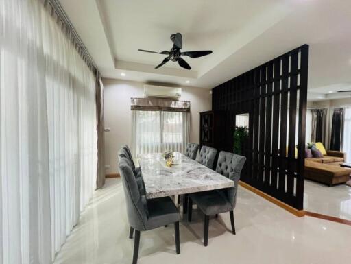 spacious dining area with a marble table and modern decor