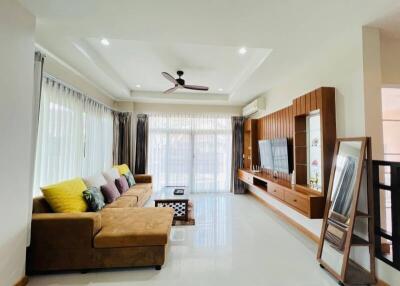 Spacious and modern living room with a large L-shaped sofa and entertainment center