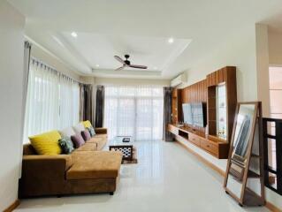 Spacious and modern living room with a large L-shaped sofa and entertainment center