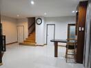 Main living space with stairwell, bar stool, and doorways