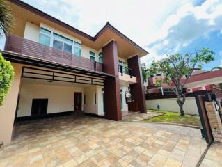 Front view of a modern house with tiled driveway and green yard