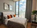 Modern bedroom with large window and city view