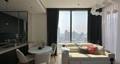 Modern living area with city view, dining space, and stylish decor