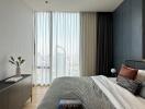 Modern bedroom with large window and city view